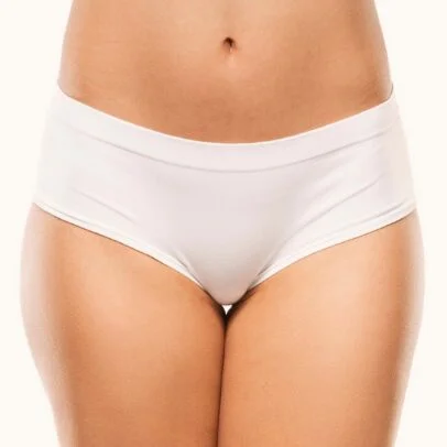 Close-up of a person's midsection wearing white seamless underwear (briefs) on light skin.