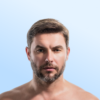 Close-up portrait of a shirtless man with short brown hair and a trimmed beard against a pale blue gradient background.