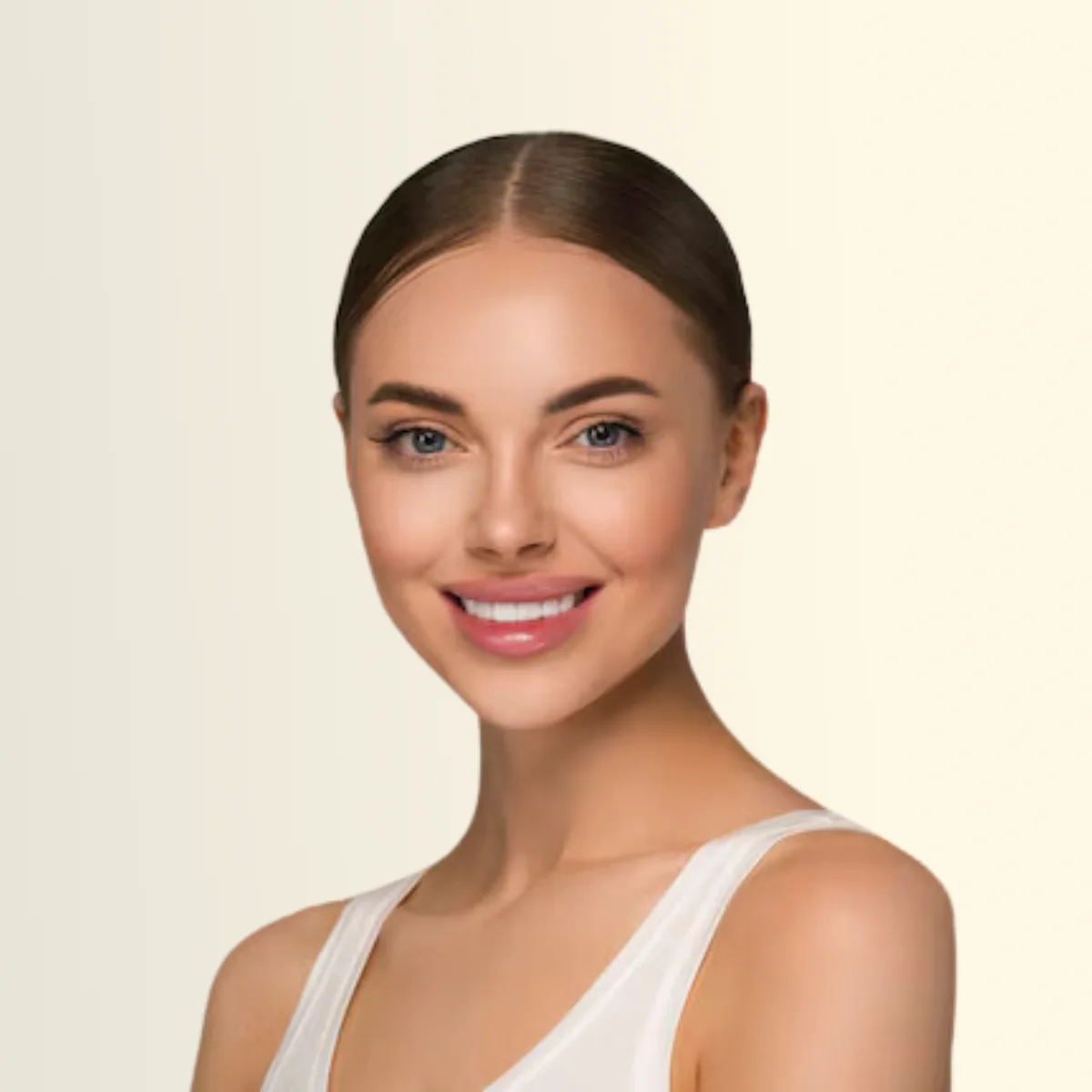 Portrait of a smiling woman with dark hair pulled back, wearing a white tank top against a pale beige background.