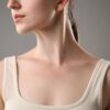 Close-up profile of a woman's neck and lower face, wearing a cream ribbed tank top.
